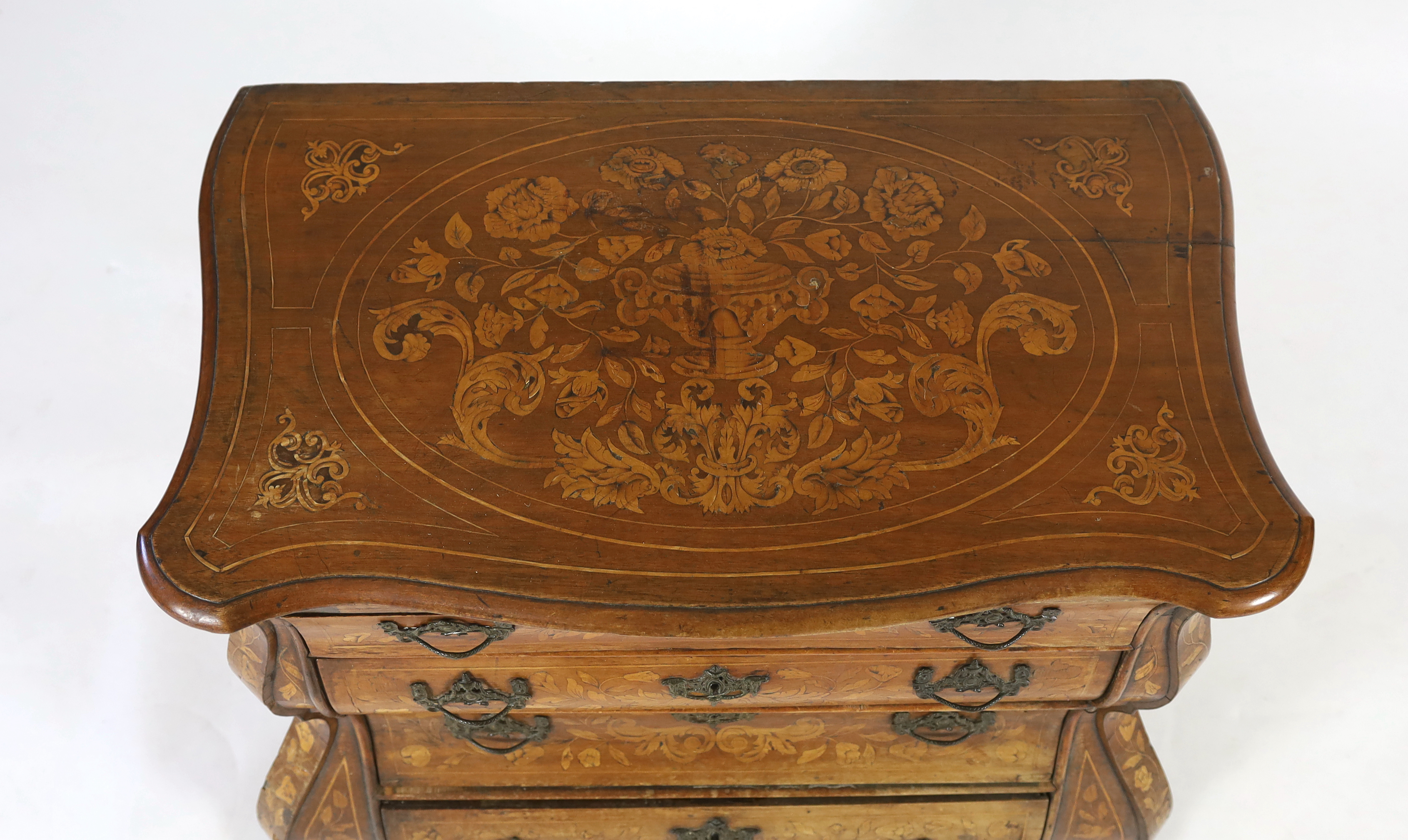 An early 19th century Dutch walnut and marquetry bombé front commode, width 110cm, depth 60cm, height 87cm